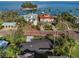 Aerial view of luxury waterfront homes with lush landscaping and private docks at 100 Buena Vista S Dr, Dunedin, FL 34698