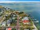 Stunning aerial view of waterfront homes, featuring picturesque architecture and waterfront access at 100 Buena Vista S Dr, Dunedin, FL 34698