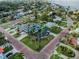 Beautiful neighborhood aerial showcasing mature trees, brick streets, and well-maintained lawns at 100 Buena Vista S Dr, Dunedin, FL 34698