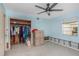 Bedroom with ceiling fan and closet, showing signs of water damage needing repair and renovation at 100 Buena Vista S Dr, Dunedin, FL 34698