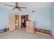 Bedroom featuring ceiling fan, closet with wood paneling, and dresser, needs TLC and renovation at 100 Buena Vista S Dr, Dunedin, FL 34698
