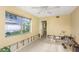 Bright living room with a large window offering natural light at 100 Buena Vista S Dr, Dunedin, FL 34698