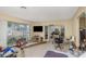 Living room with large windows showing outside view and french doors at 100 Buena Vista S Dr, Dunedin, FL 34698