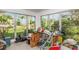 Sun room with many windows, a view of a tropical landscape, and tile floors at 100 Buena Vista S Dr, Dunedin, FL 34698