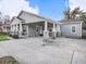 Side view of home featuring a covered carport with stone column base and lush landscaping at 1003 W Reynolds St, Plant City, FL 33563