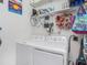 Laundry room with new washer and dryer units and utility shelving at 1003 W Reynolds St, Plant City, FL 33563