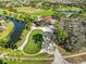 Aerial view of a golf course and clubhouse showcasing the community amenities and scenic surroundings at 11218 Longbrooke Dr, Riverview, FL 33579