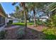 Beautifully landscaped backyard with a mix of trees, shrubs, and a well-maintained lawn, ideal for outdoor enjoyment at 11218 Longbrooke Dr, Riverview, FL 33579