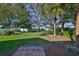A lush backyard featuring a well-manicured lawn and mature trees, creating a private and tranquil outdoor space at 11218 Longbrooke Dr, Riverview, FL 33579