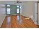 Bright bedroom with hardwood floors, large windows, and a ceiling fan at 11218 Longbrooke Dr, Riverview, FL 33579