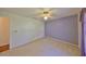Bedroom with ceiling fan, neutral carpet, and paneled accent wall at 11218 Longbrooke Dr, Riverview, FL 33579