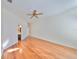 Spacious bedroom with hardwood floors, ceiling fan, and attached bathroom with a linen closet at 11218 Longbrooke Dr, Riverview, FL 33579