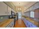 Well-lit kitchen featuring stainless steel appliances, granite counters, and hardwood floors at 11218 Longbrooke Dr, Riverview, FL 33579