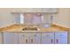 Kitchen features a breakfast bar with granite countertops and stainless steel sink at 11218 Longbrooke Dr, Riverview, FL 33579