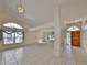 Bright living room with high ceilings, tile flooring, large windows, and a chandelier at 11218 Longbrooke Dr, Riverview, FL 33579