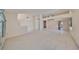 Spacious living room with neutral walls and flooring, open floor plan, and natural lighting at 11218 Longbrooke Dr, Riverview, FL 33579
