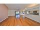 Spacious living room featuring hardwood floors and sliding glass doors to the screened patio at 11218 Longbrooke Dr, Riverview, FL 33579