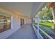 Enclosed patio area featuring tiled floor, sliding glass doors and view of the backyard at 11218 Longbrooke Dr, Riverview, FL 33579