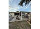 Backyard featuring a fire pit, outdoor kitchen, and covered patio, ideal for outdoor entertaining at 1149 6Th Ne Ave, Largo, FL 33770
