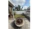Backyard area with a fire pit and newly installed grass, offering a cozy outdoor space for relaxation at 1149 6Th Ne Ave, Largo, FL 33770