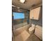 Bathroom with updated white cabinets, granite counters, shower over tub, and updated fixtures at 1149 6Th Ne Ave, Largo, FL 33770
