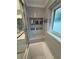 Tub with shower featuring updated shower with niche storage and a window for natural lighting at 1149 6Th Ne Ave, Largo, FL 33770