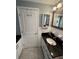 Nicely remodeled bathroom with vanity, sink, white cabinets and tile floors at 1149 6Th Ne Ave, Largo, FL 33770