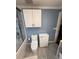 Toilet with updated white cabinets above for extra storage and updated fixtures at 1149 6Th Ne Ave, Largo, FL 33770