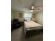 Bright bedroom featuring a queen size bed, ceiling fan, and comfortable chair at 1149 6Th Ne Ave, Largo, FL 33770