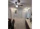 Neutral bedroom with a ceiling fan, double door closet and side table at 1149 6Th Ne Ave, Largo, FL 33770