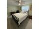 Neutral bedroom with a ceiling fan, dresser, and comfortable queen bed at 1149 6Th Ne Ave, Largo, FL 33770