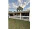 Inviting front porch with white railing and comfortable swing for relaxation at 1149 6Th Ne Ave, Largo, FL 33770