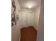 Hallway with hardwood floors and two white paneled doors at 1149 6Th Ne Ave, Largo, FL 33770