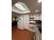 Bright kitchen features white cabinets, modern appliances, and wood-look flooring at 1149 6Th Ne Ave, Largo, FL 33770