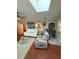 Open-concept living room with skylight, comfortable seating, and stylish decor at 1149 6Th Ne Ave, Largo, FL 33770