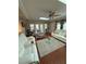 Bright living room featuring a skylight, ceiling fan, and comfortable white couches at 1149 6Th Ne Ave, Largo, FL 33770