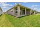 Lush green backyard with a covered patio, ideal for enjoying outdoor living at 11842 Richmond Trl, Parrish, FL 34219