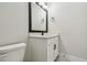 Contemporary bathroom featuring a vanity with a black faucet and a well-lit mirror at 11842 Richmond Trl, Parrish, FL 34219