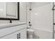 Well-lit bathroom featuring white cabinets, a quartz countertop, and modern black fixtures at 11842 Richmond Trl, Parrish, FL 34219