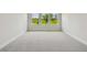 Spacious, carpeted bedroom with three windows providing natural light at 11842 Richmond Trl, Parrish, FL 34219