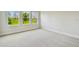 Bright bedroom with plush carpeting and multiple windows offering exterior views at 11842 Richmond Trl, Parrish, FL 34219