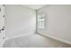 Bright bedroom with neutral carpet and a window providing natural light at 11842 Richmond Trl, Parrish, FL 34219