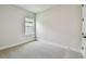 Cozy bedroom with neutral carpet and a window, perfect for relaxation and rest at 11842 Richmond Trl, Parrish, FL 34219