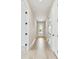 Hallway with wood floors leading to a glass door with black hardware at 11842 Richmond Trl, Parrish, FL 34219