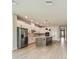 Modern kitchen features stainless steel appliances, large center island and an open floor plan at 11842 Richmond Trl, Parrish, FL 34219