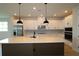 Bright kitchen featuring a spacious island, white cabinetry, and modern appliances at 11842 Richmond Trl, Parrish, FL 34219