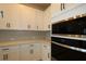 Close-up of modern built-in stainless oven and white countertops at 11842 Richmond Trl, Parrish, FL 34219