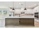 Spacious kitchen with quartz counters, stainless appliances, and modern pendant lighting at 11842 Richmond Trl, Parrish, FL 34219