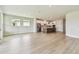Spacious living room with hardwood floors leading to the kitchen area at 11842 Richmond Trl, Parrish, FL 34219