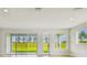 Bright and airy living room featuring a wall of glass doors with scenic views at 11842 Richmond Trl, Parrish, FL 34219